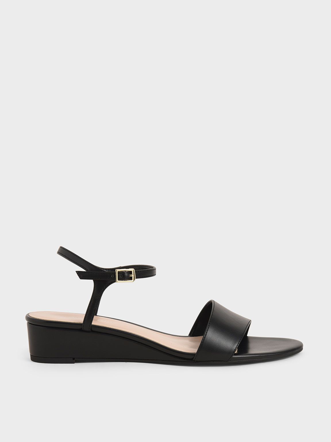 Gemma Asymmetric Wedge Sandals in Black, product photograph